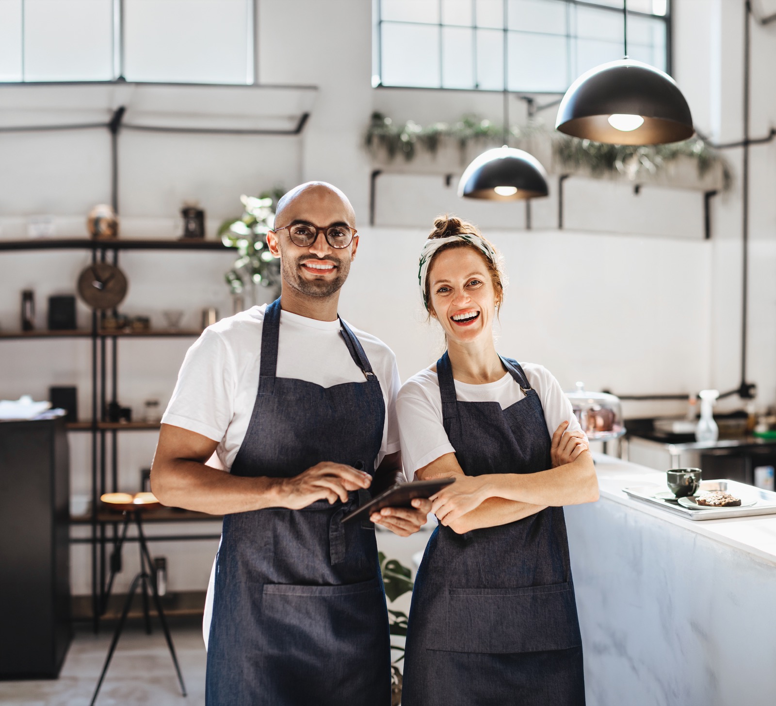 Café owners with tablets – the benefits of PragmaCash loans for merchants